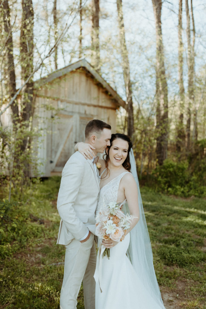 A smiling bride with her fiance at L & L farm captured by a Nashville Wedding Photographer.