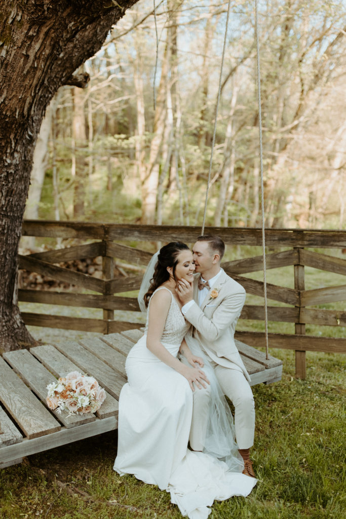 Couple snuggling close on a swing at a wedding venue near Nashville, Tennessee.