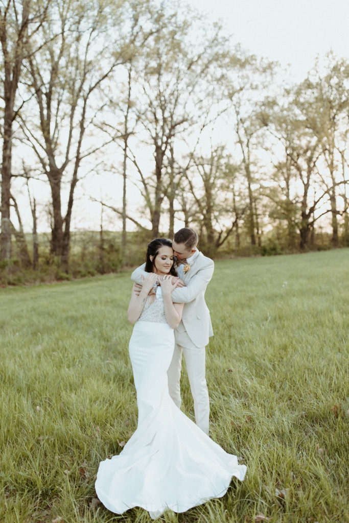 A romantic moment caught in the field at L & L farm by a Nashville Wedding photographer.