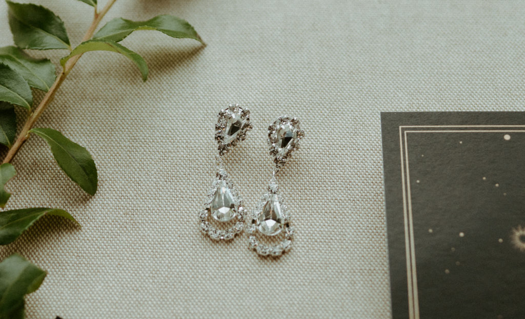 Shelby's earrings setup in the flatlay during her wedding day. 