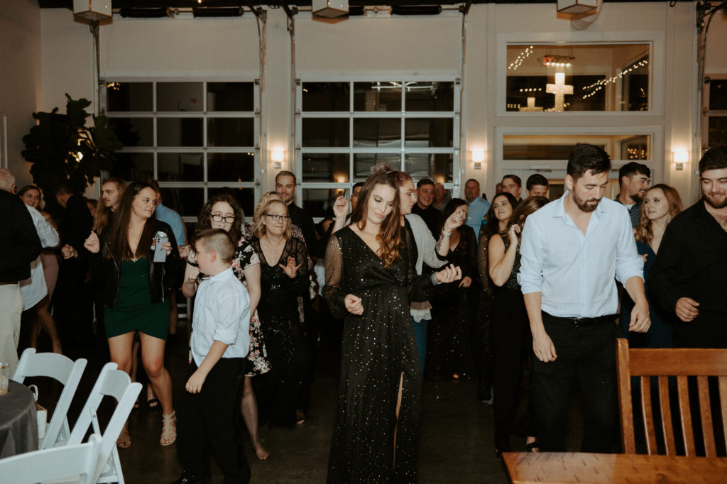 Everyone dancing to the cha cha slide during the reception at The Ruby Cora. 