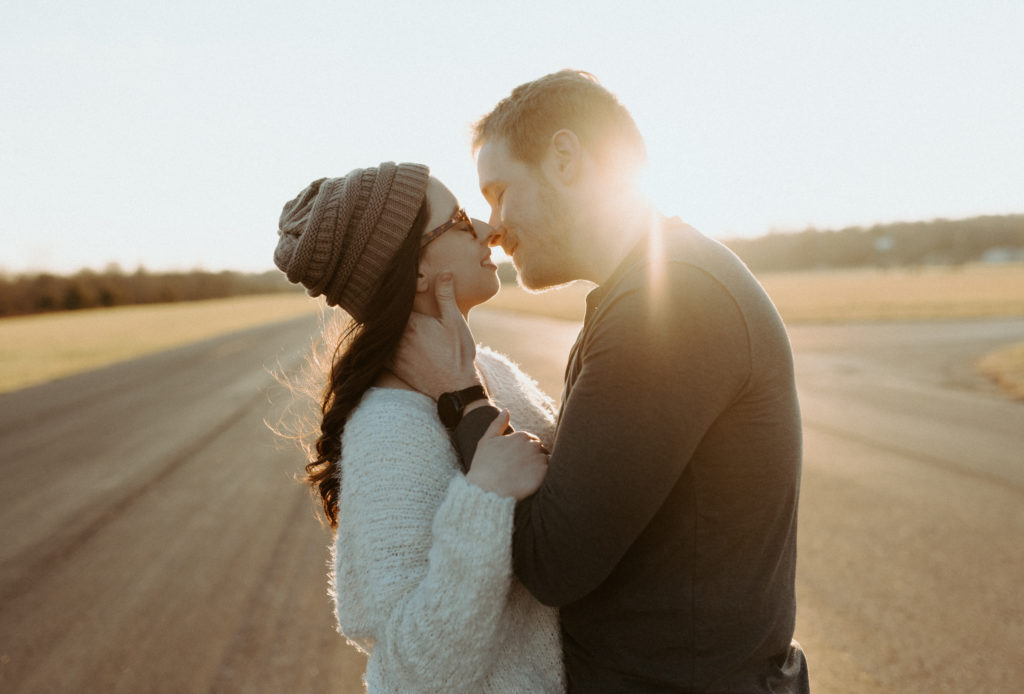 A glowy sunset kiss during a fall engagement session at Cornelia Fort Airport in Nashville. 