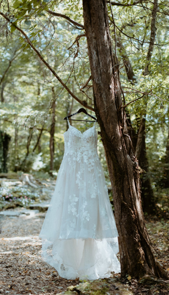 Kayla's wedding dress hanging for detail shots at The Wedding woods Venue in Lebanon, Tennessee.  