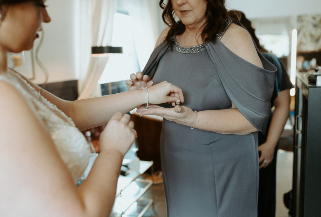 Marissa's mother helping her get get ready on her wedding day.