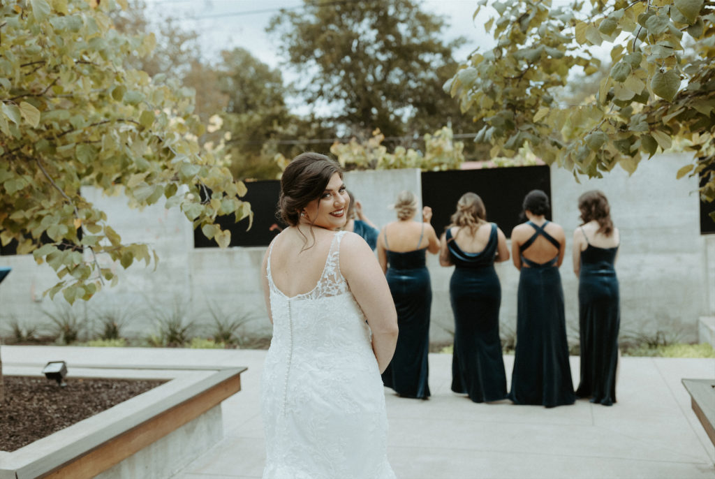 Marissa getting ready for a first look with her bridesmaids during her fall wedding at Clementine Hall.