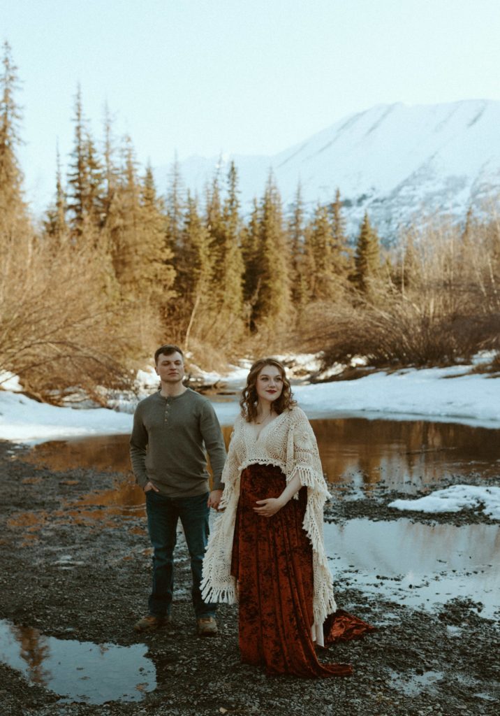 Ashley and Dakota looking at the mountains during their maternity photoshoot.