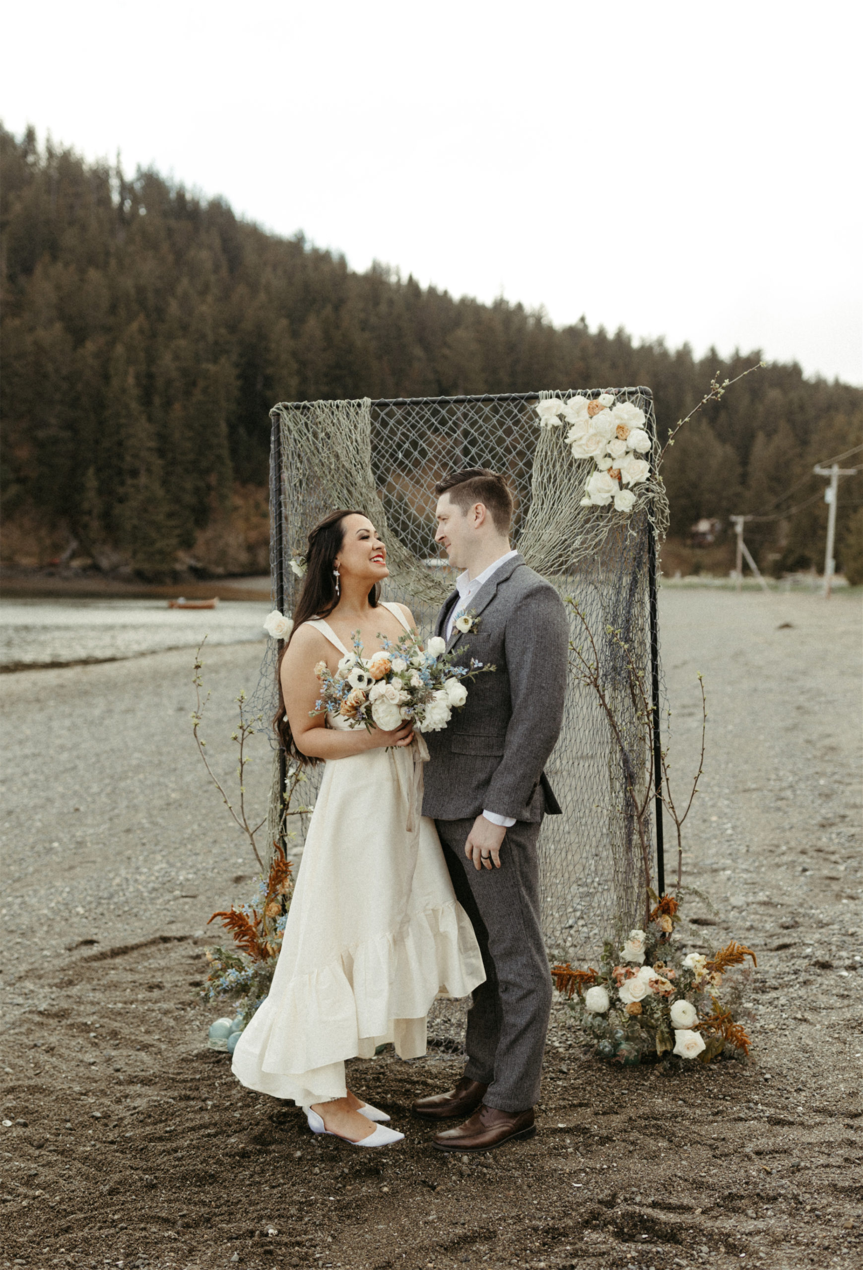 Couple getting married and celebrating their wedding on the Beach in Homer, Alaska 