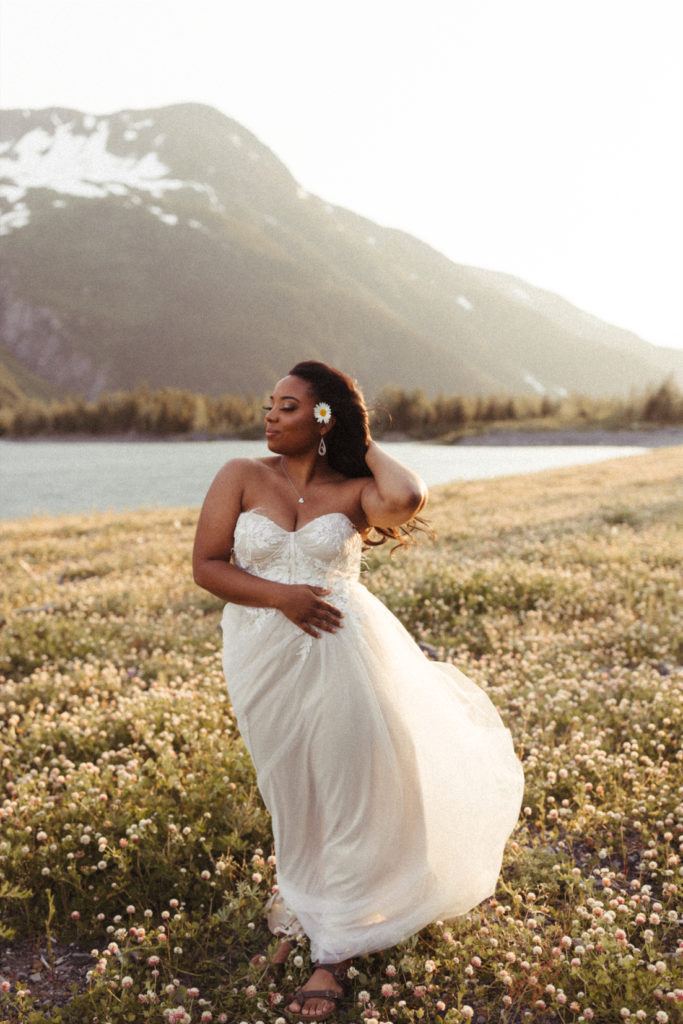 Woman holding her hair back in the wind during a bridal session