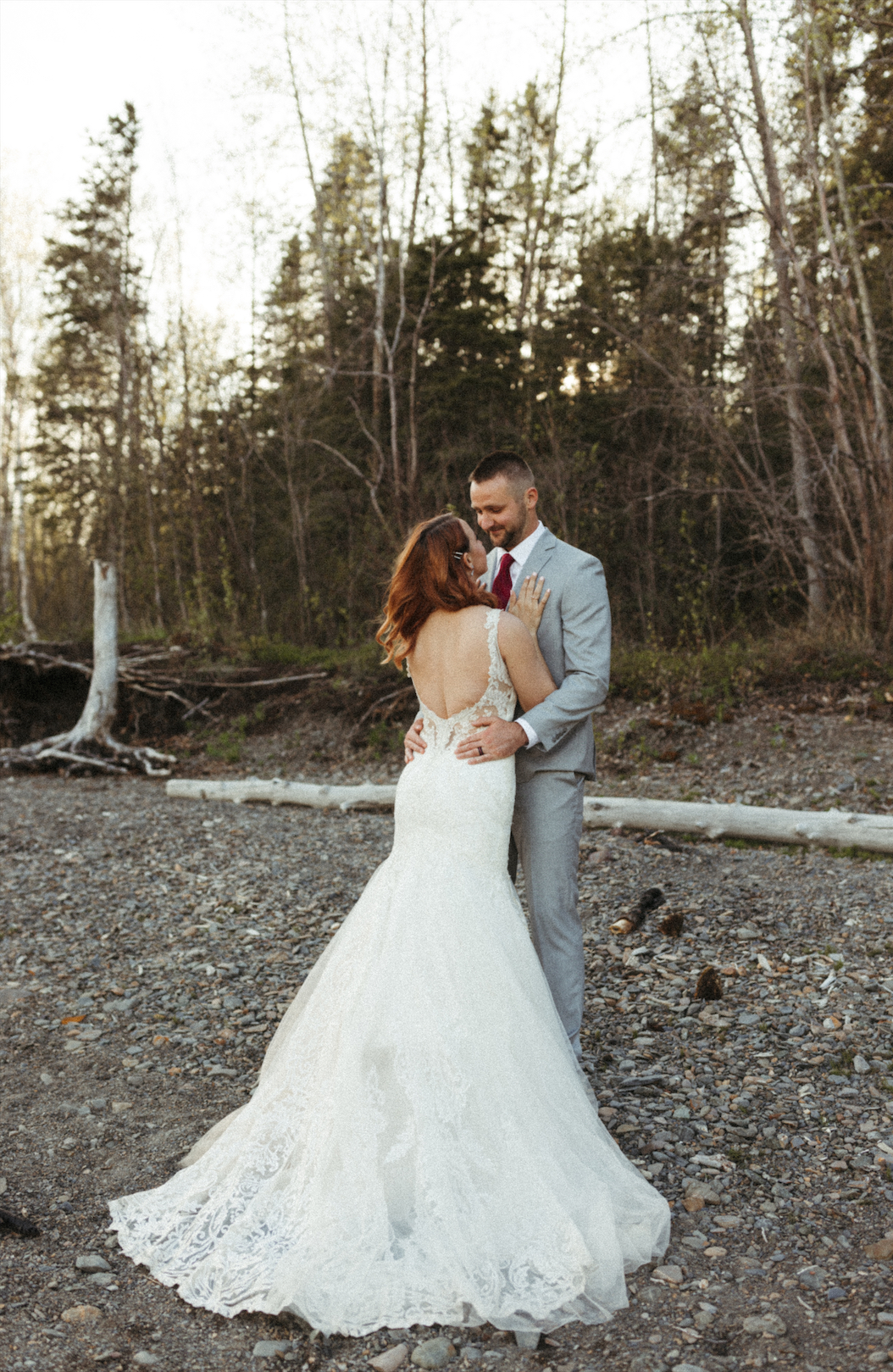 Couple on the shore of Eklutna Lake during their wedding anniversary photo session