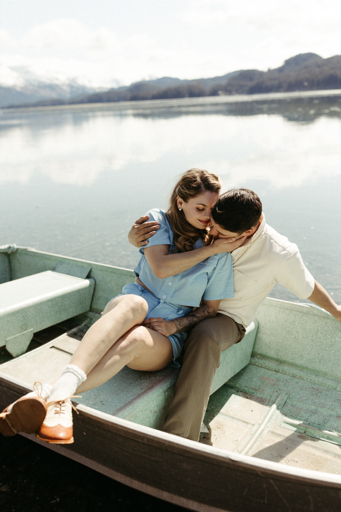 Couple snuggling in a boat during their engagement photos