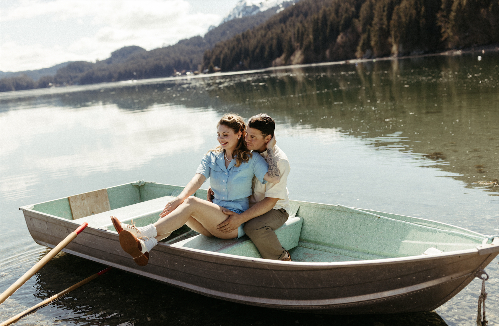 Couple smiling in a boat during their spring engagement session
