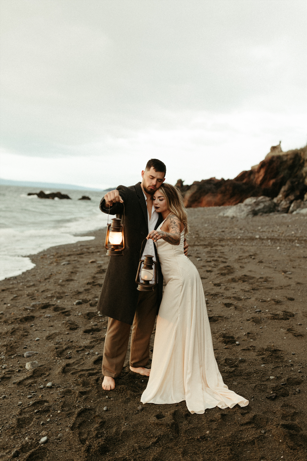 Couple holding lanterns during their Alaska wedding 
