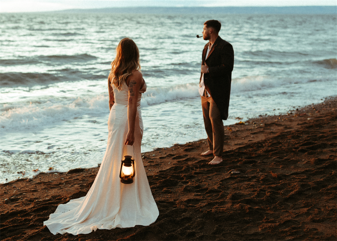 Bride and groom looking out to the sea during a wedding photoshoot in Seldovia, Alaska.