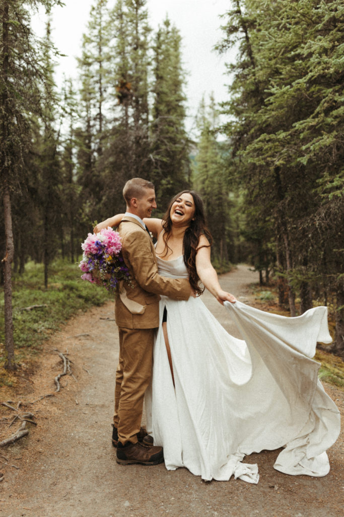 Couple laughing in the woods on their elopement day