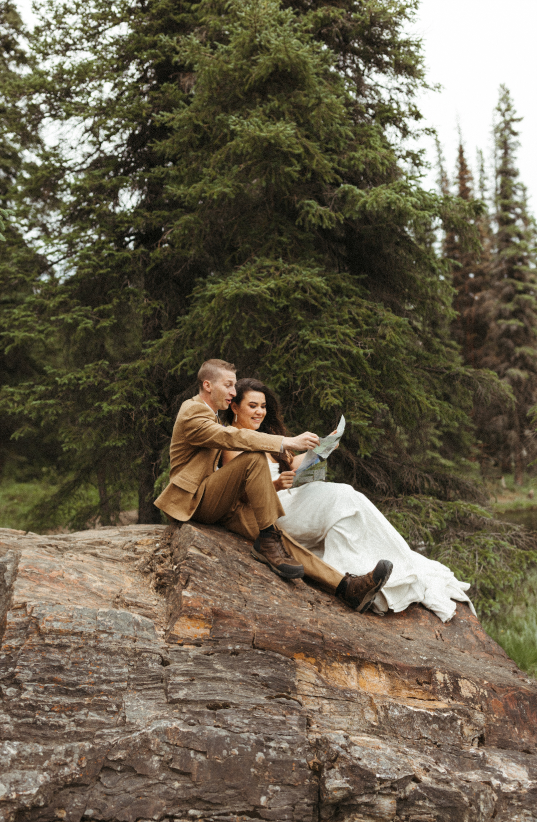 Couple sitting on a rock during their elopement in Denali National Park 