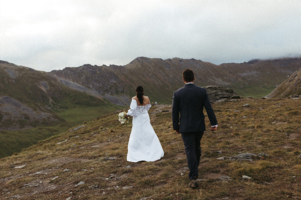 Couple walking toward the mountains 