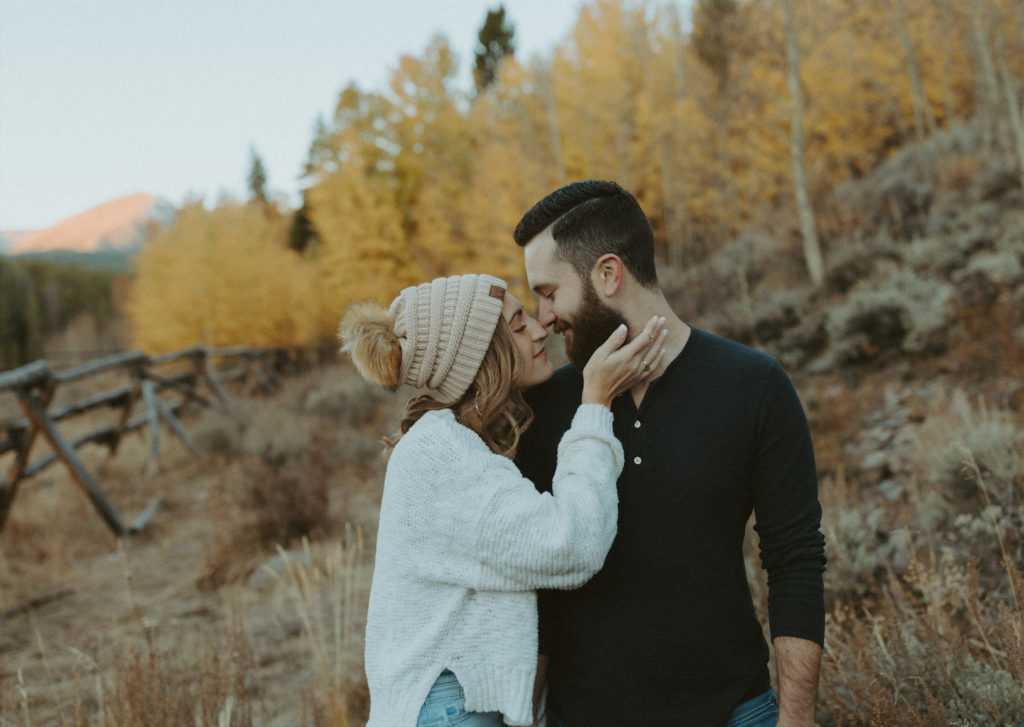 Couple snuggled close during their engagement session in Breckenridge, Colorado