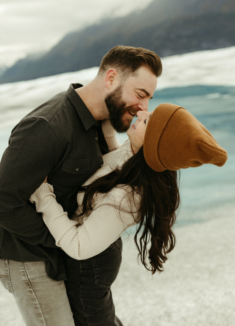 couple almost kissing on Knik Glacier in Alaska