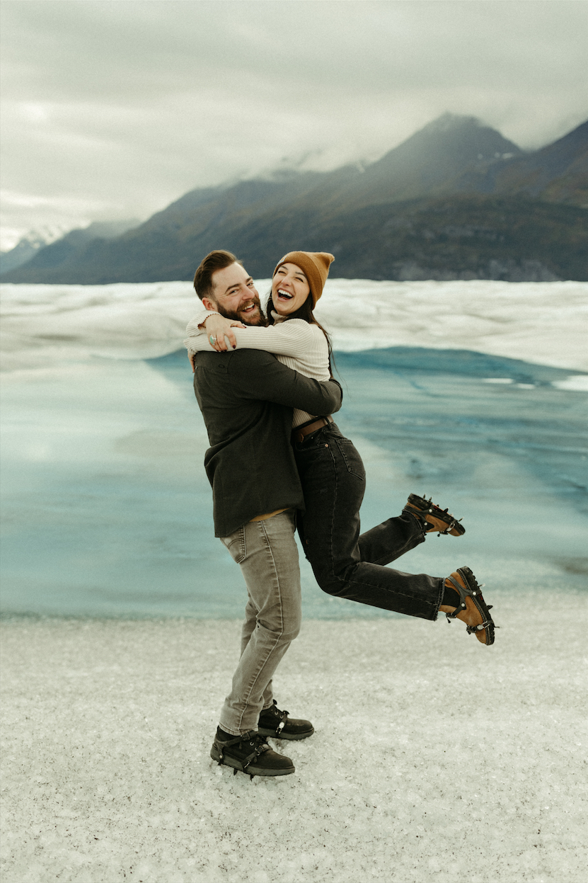 Couple holding eachother during their engagement session on Knik Glacier in Alaska