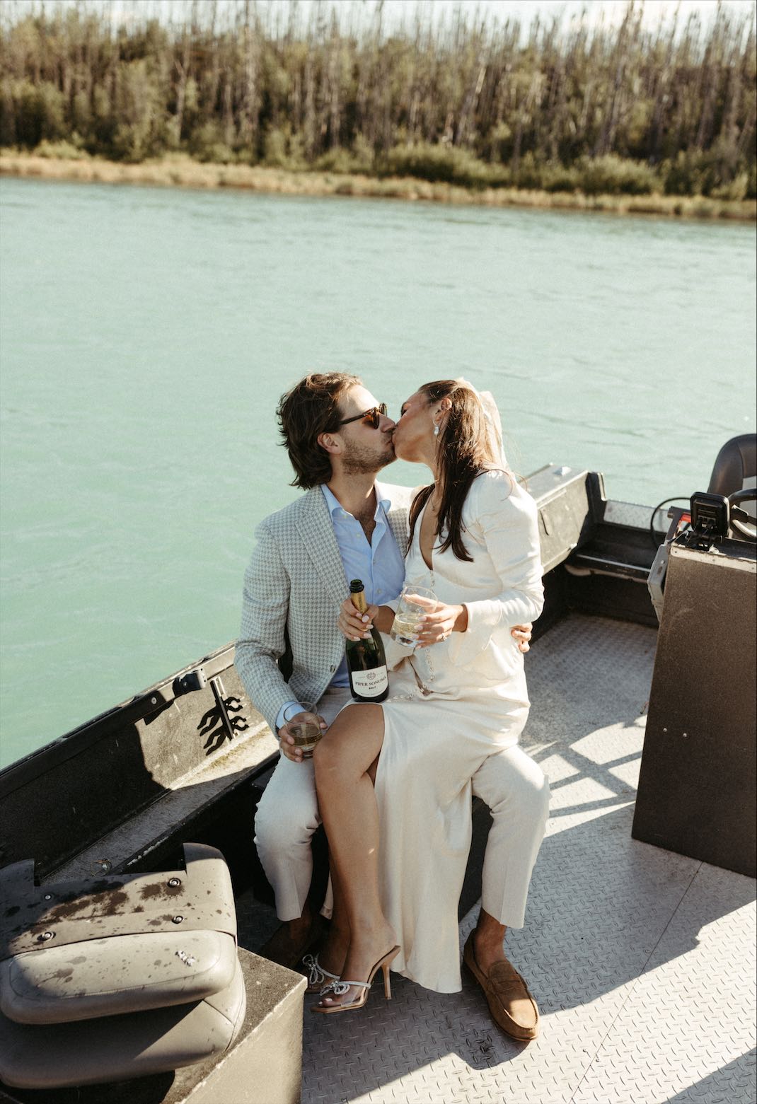 couple kissing during their boat wedding photos