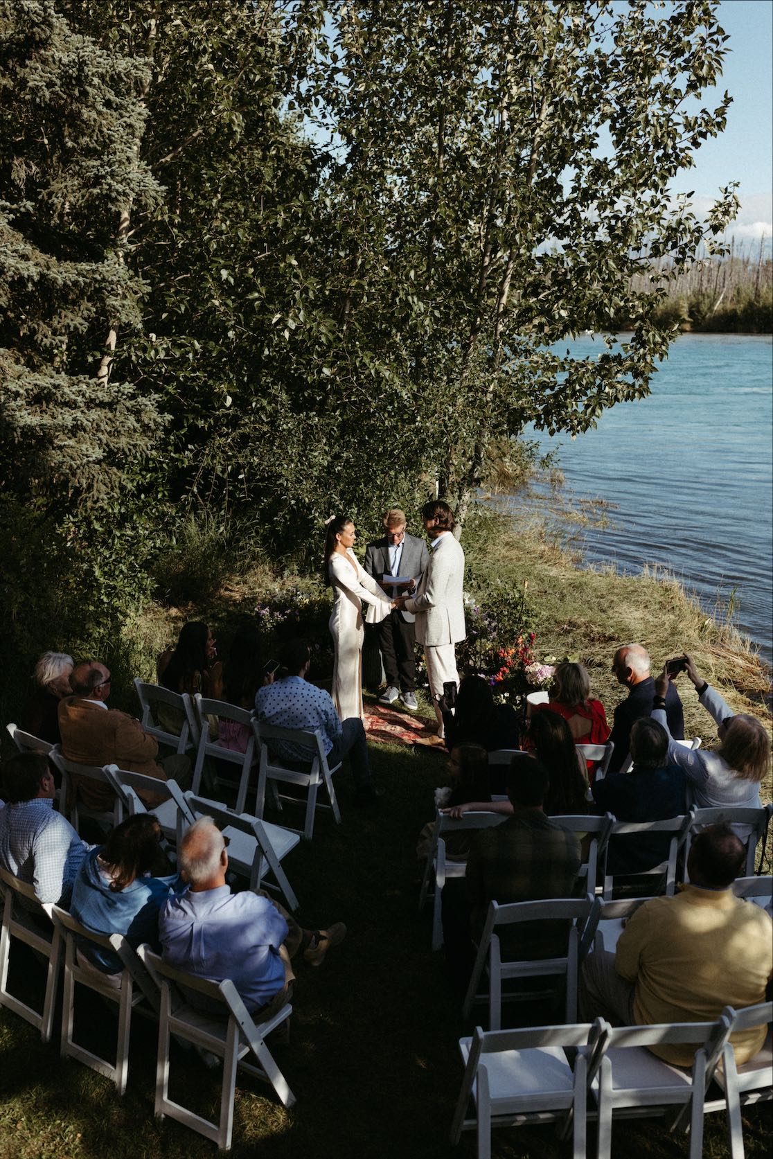 Couple surrounded by their family and friends during their Alaska wedding day