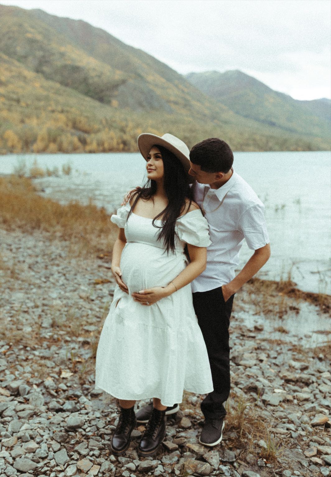 Couple snuggled close during a maternity session