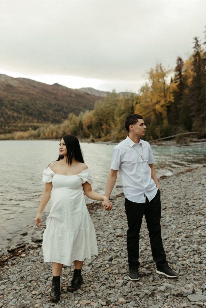 Couple holding hands during a maternity session in Alaska