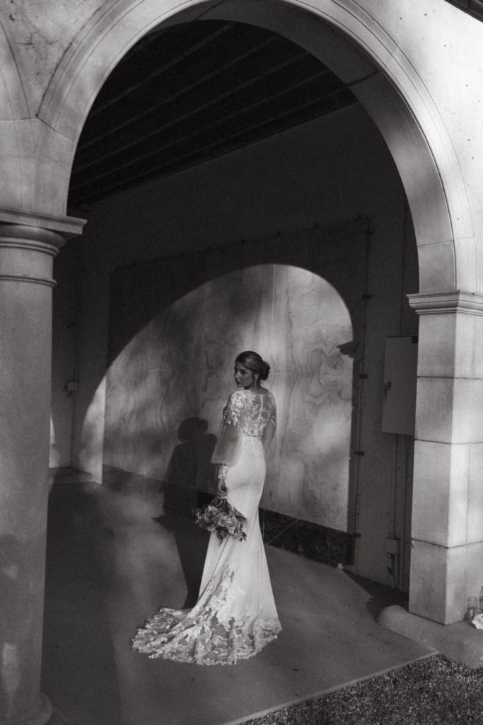 Bride standing inside an arch at the venue
