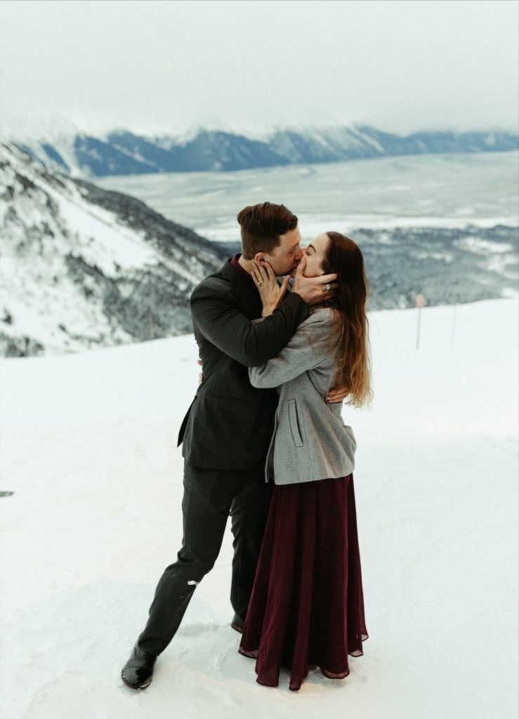 Couple kissing after their Alaska proposal session
