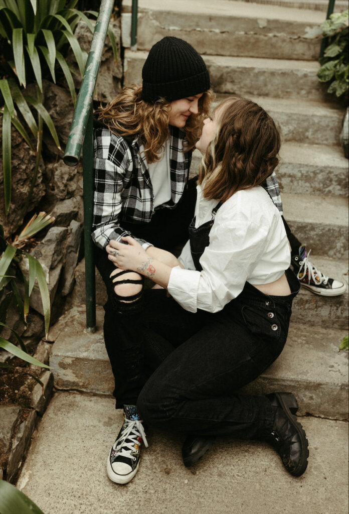 Couple talking with one another while sitting on steps 
