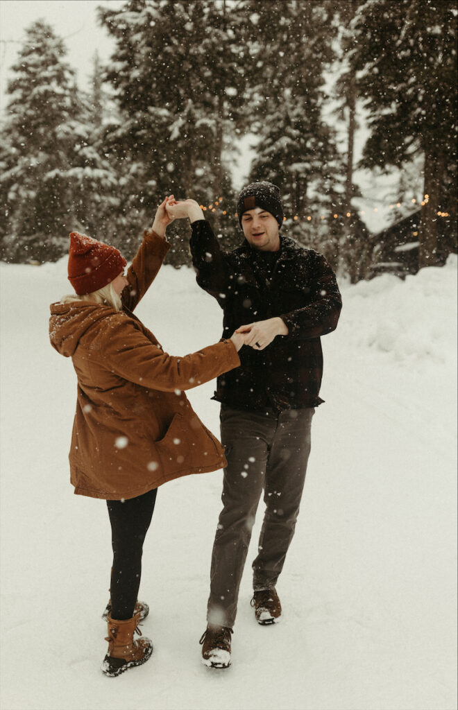 Couple dancing in the streets filled with snow