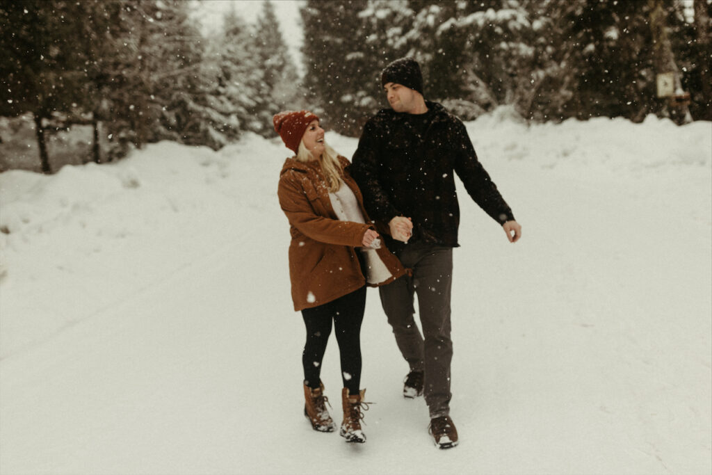 Couple walking hand and hand during their winter engagement photos