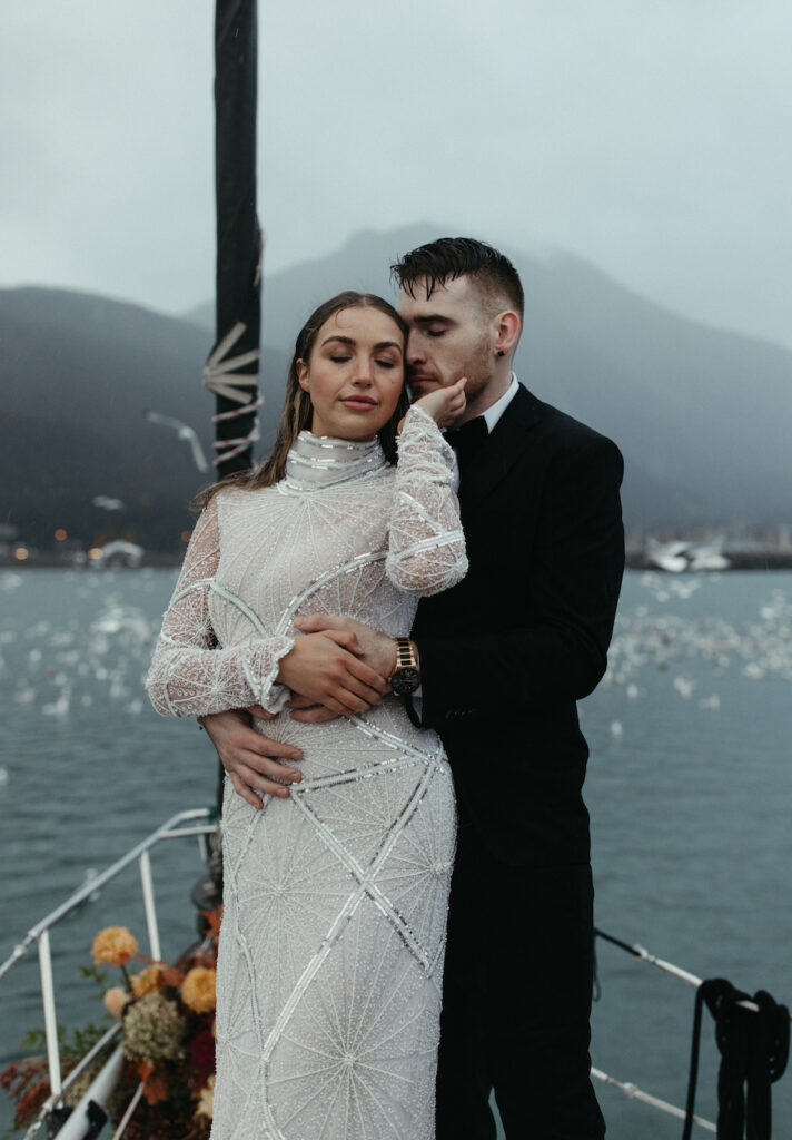 Couple standing together on a boat during their elopement in Seward, Alaska