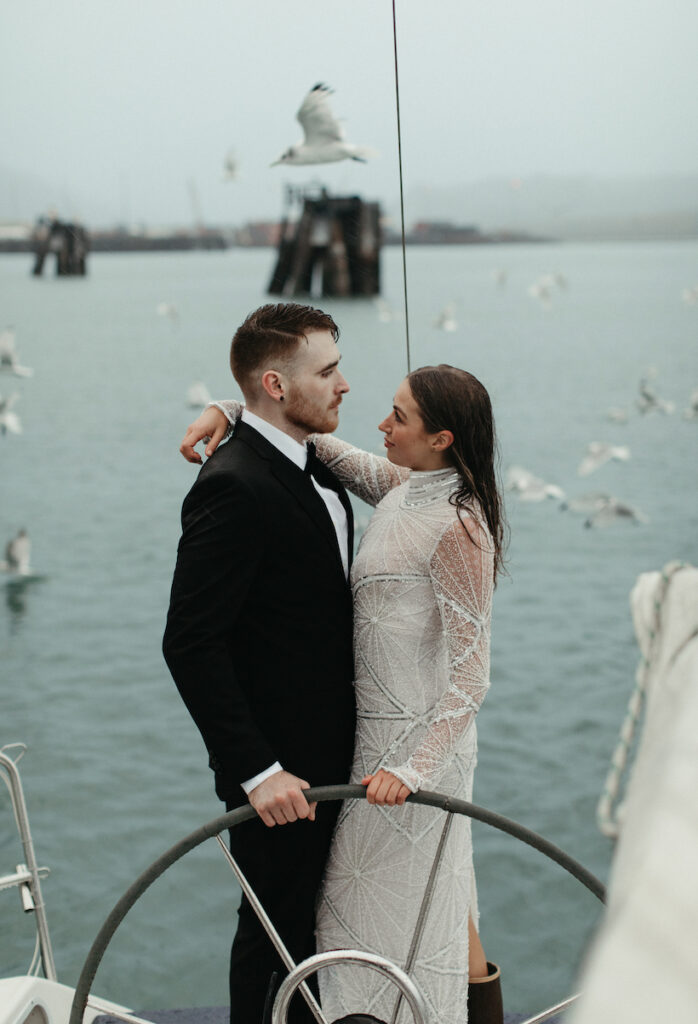 Couple holding onto one another during their elopement in Seward, Alaska. 