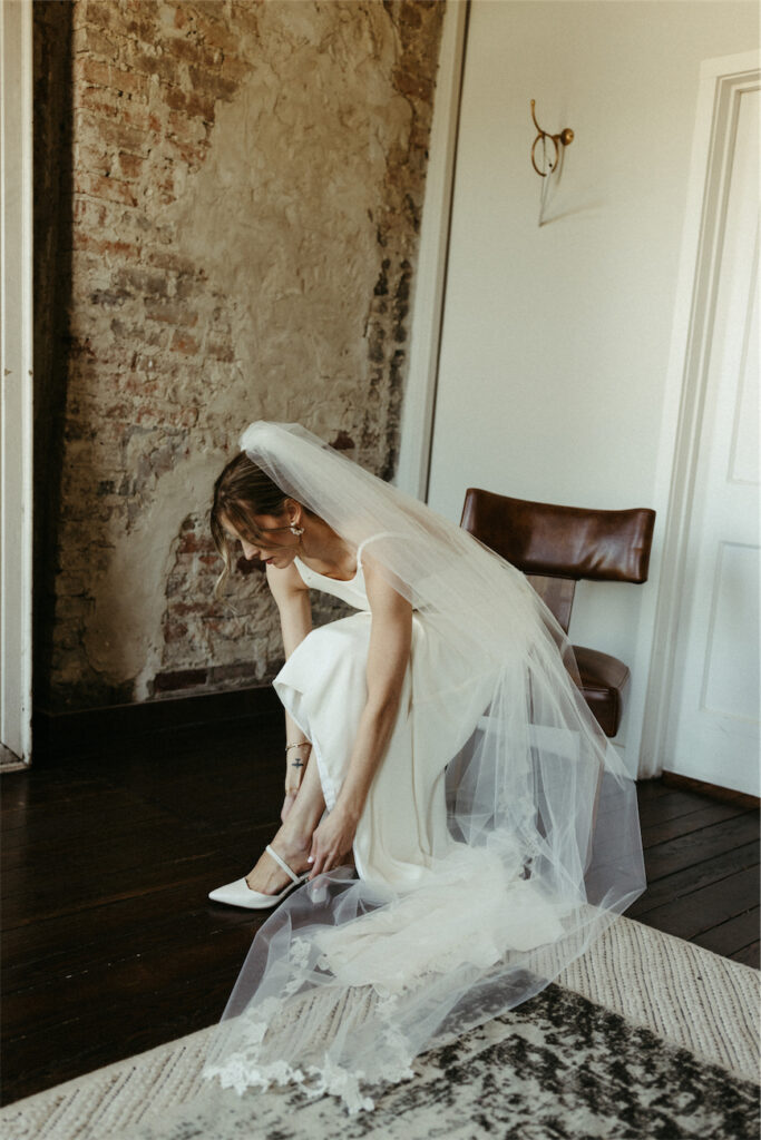 Bride putting on her shoes at one of the best wedding venues in Nashville