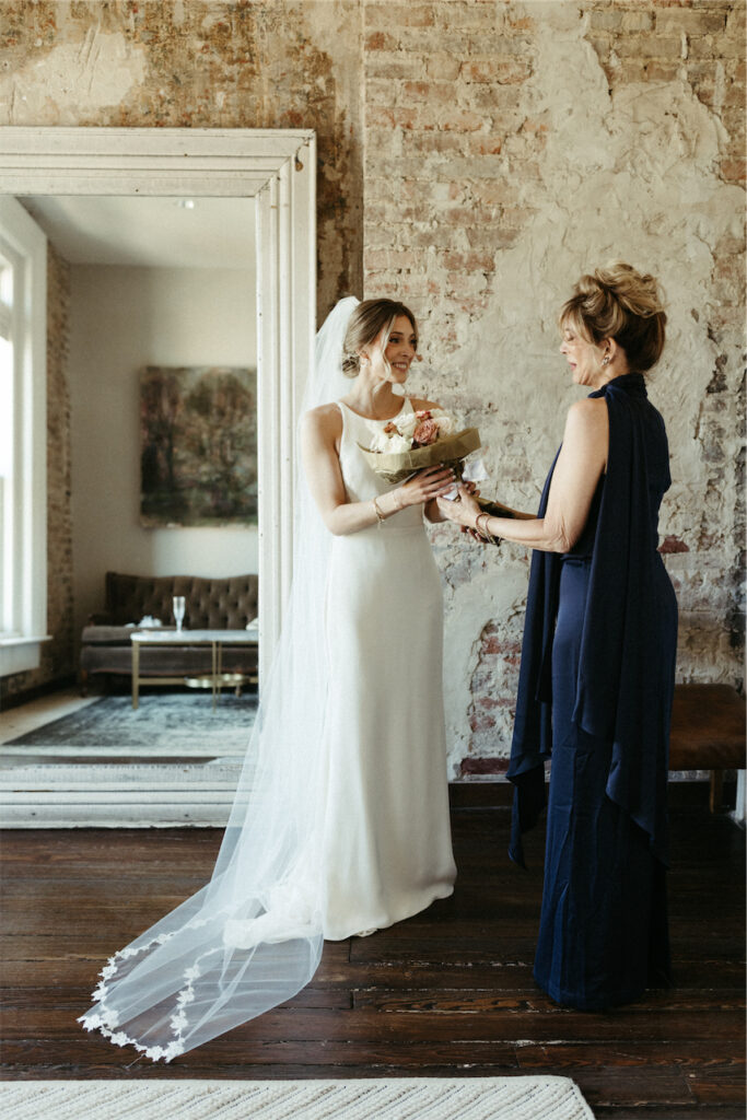 mother giving florals to her daughter during a wedding at one of the best venues in Nashville