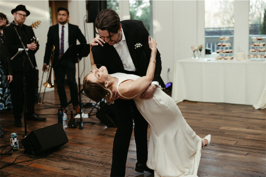 Groom dipping the bride during their first dance during their wedding reception at The Cordelle
