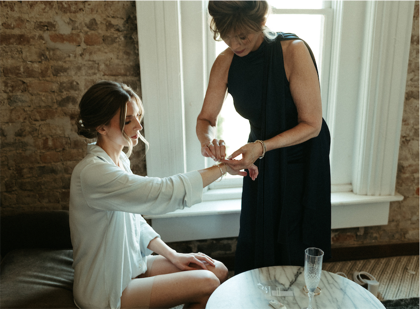 Mom helping her daughter put on jewelry at one of the best wedding venues in Nashville