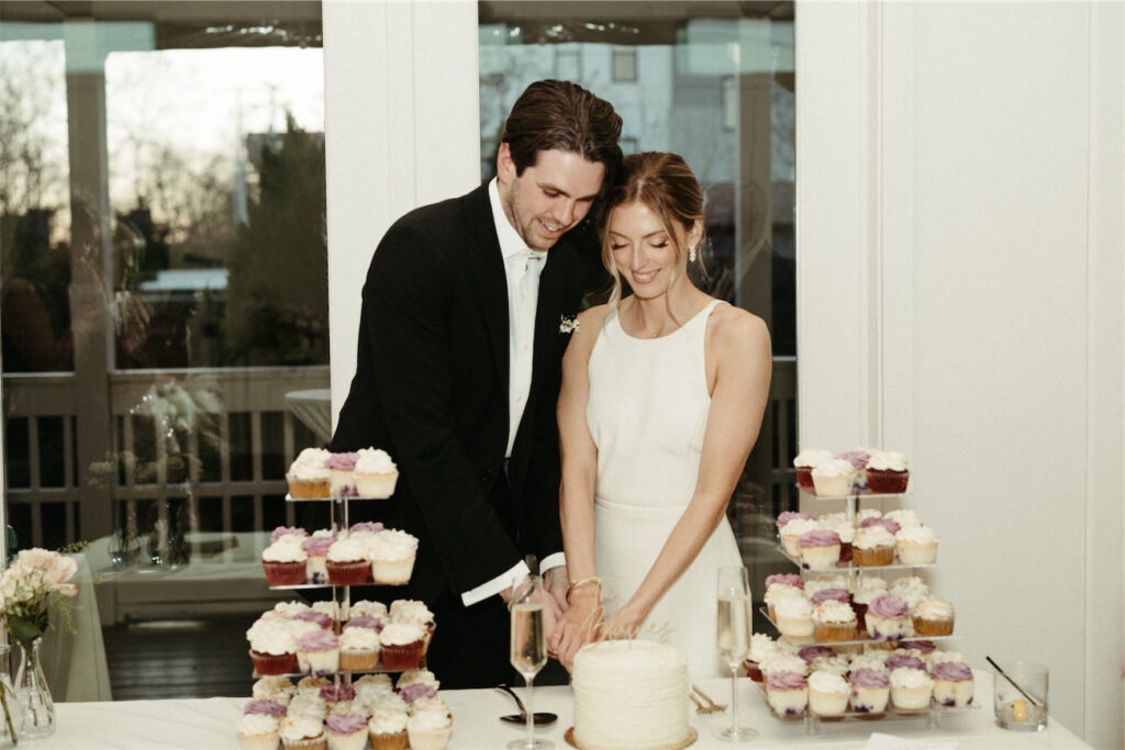 Couple cutting their wedding cake together 