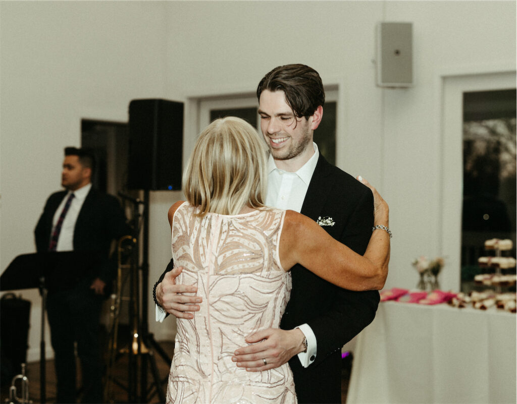 Groom dancing with his mother during a wedding reception at The Cordelle