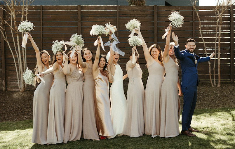 Bridal party pumping their bouquets in excitement