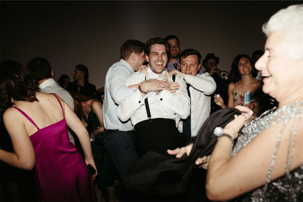 Groom goofing around with his buddies during the reception at one of the best wedding venues in Nashville