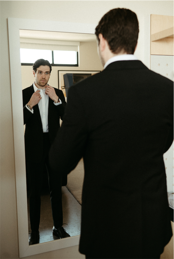 Groom adjusting his collar before heading over to see his Bride at The Cordelle