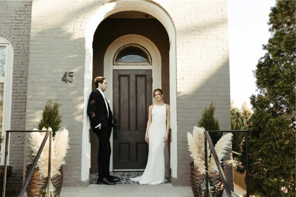 Bride and groom standing outside their wedding venue