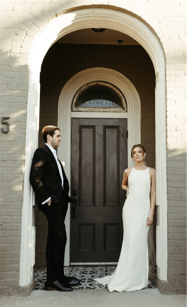 Couple standing against the wall at their wedding venue in Nashville, Tennessee