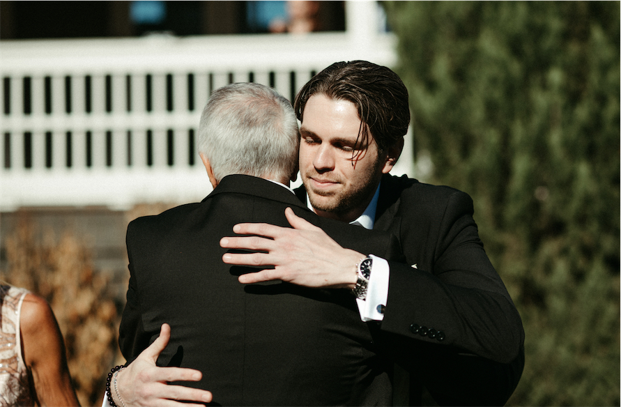 Groom hugging his father during his wedding ceremony