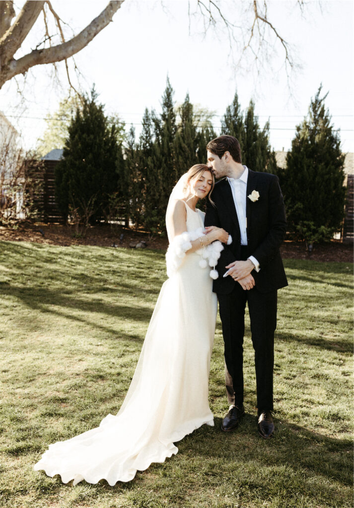 Couple snuggled close in the gardens at one of the best wedding venues in Nashville
