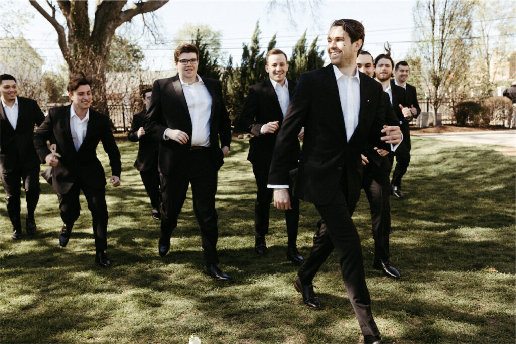 Groom and his groomsmen running at one of the best wedding venues in Nashville