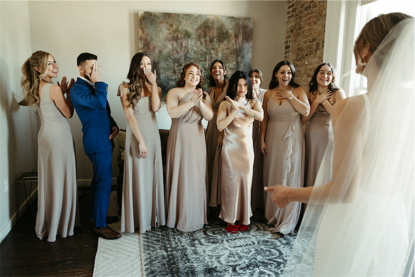 Bridal party seeing the bride for the first time in a bridal suite at one of the best wedding venues in Nashville