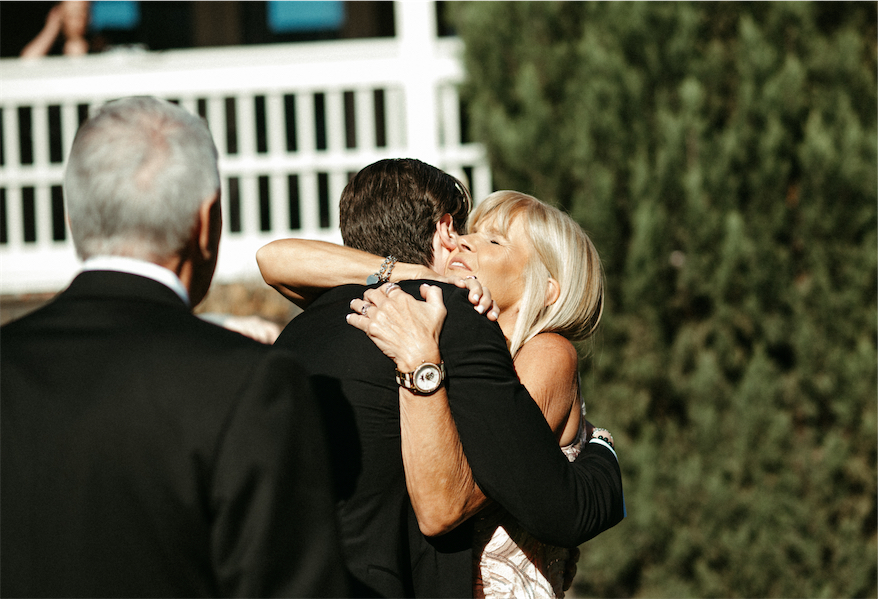 Groom hugging his mother during a wedding ceremony at one of the best wedding venues in Nashville